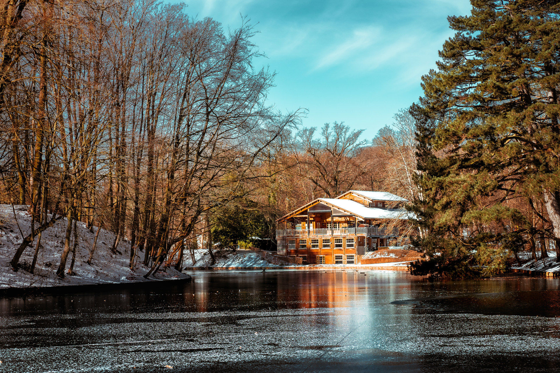 Cottage on a frozen pond in winter