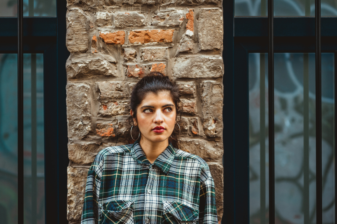 portrait of a model against a brick wall