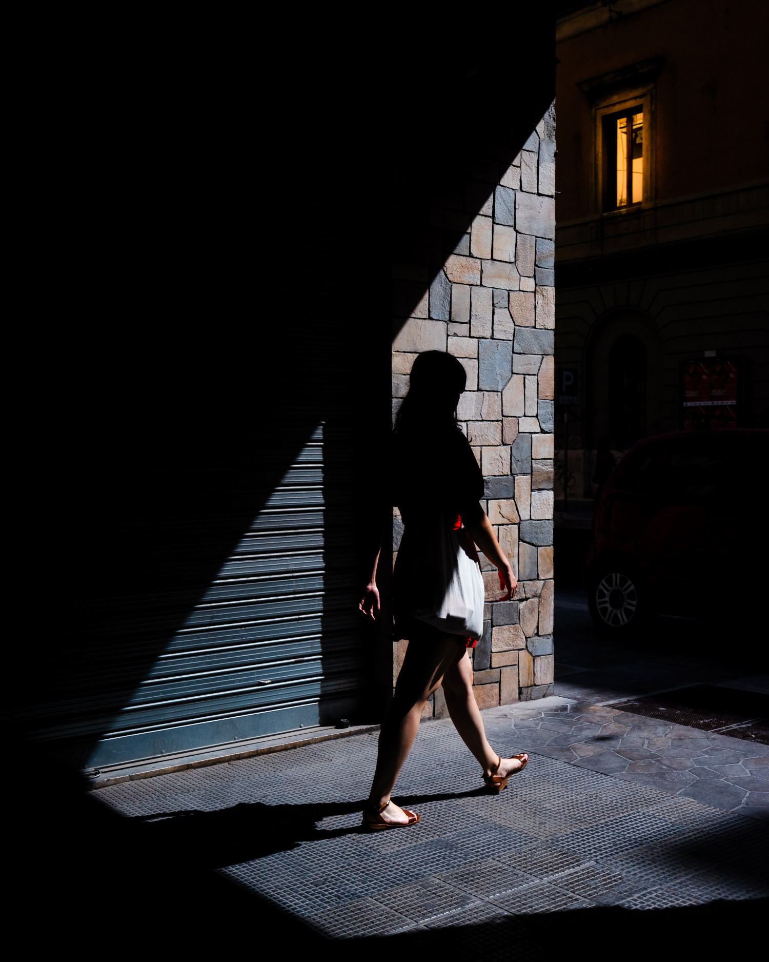 Street photograph of a girl in red in Bari