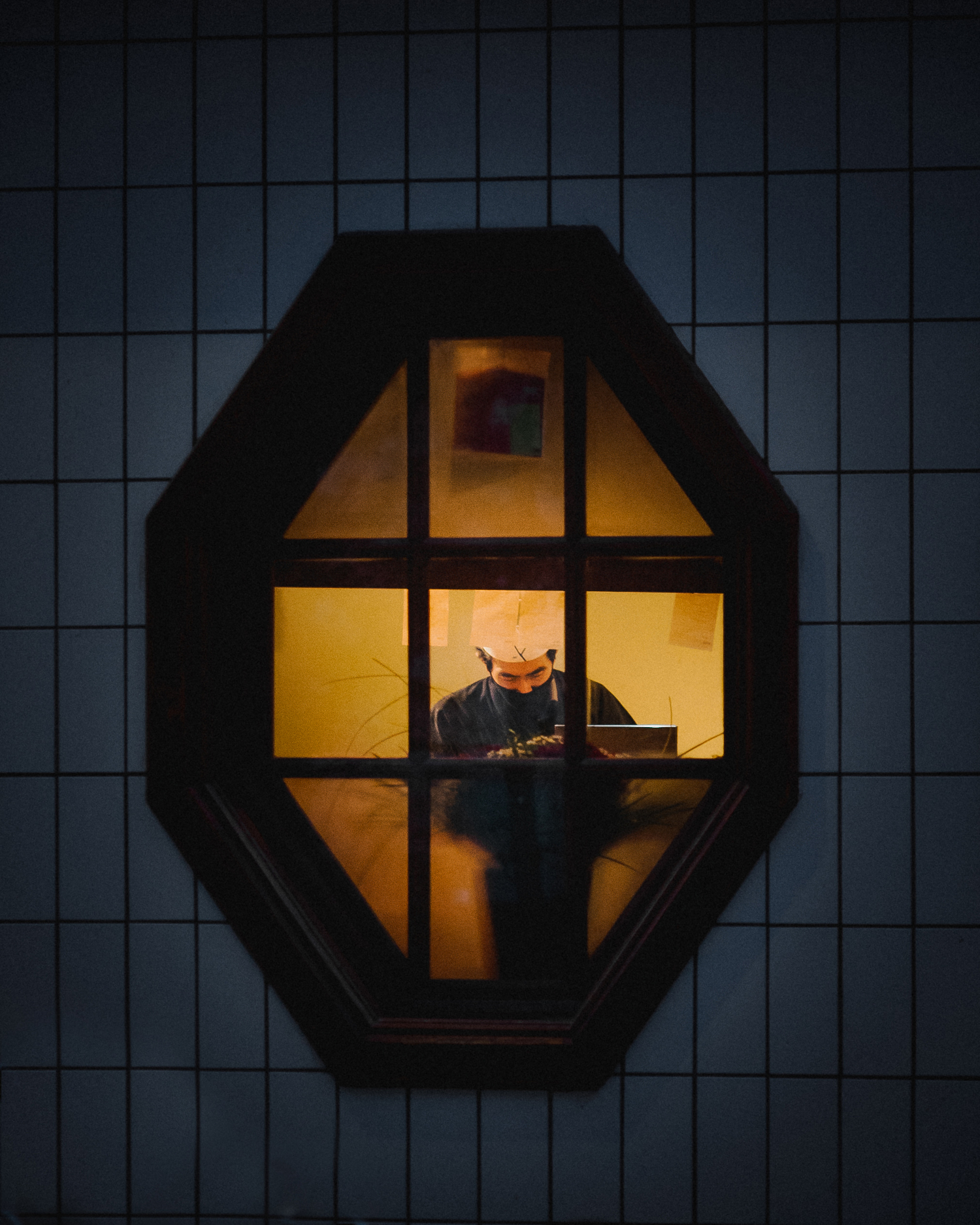 photograph of a cook through a window